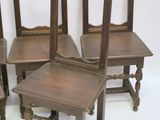 four wooden chairs are lined up against a white background