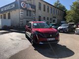 a red car parked in front of a building