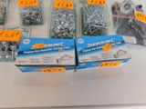 many different types of screws and nuts on the table