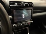 the dashboard of a car with a cell phone in the center of it