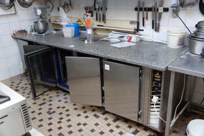 a kitchen with a sink, stove, and refrigerator in it