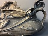a silver plate with a bird on it