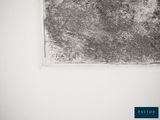 a black and white photo of a piece of art on a wall
