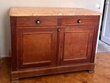 a wooden cabinet with a marble top in a room