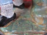 a figurine of a woman standing on top of a table