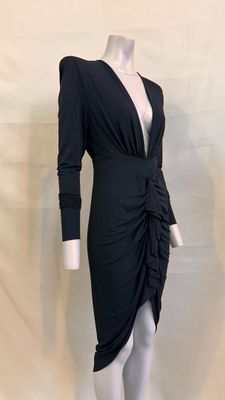 the mannequin is wearing a black dress with long sleeves