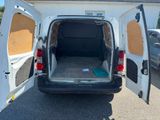 a white van with its doors open in a parking lot