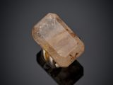 a close up of a ring with a stone on a black surface