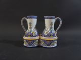 two blue and white vases sitting on top of a black table