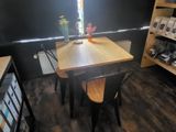 a small table and two chairs in a small room
