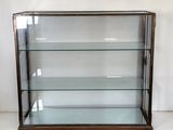 a glass display case with three shelves on top of it