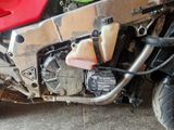 a close up of a red motorcycle parked on the side of the road