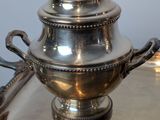 a silver plate with a silver lid on it