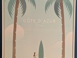 a picture of a woman holding a surfboard in front of two palm trees