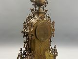 a gold clock that is sitting on a table