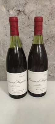 two bottles of wine sitting next to each other on a table