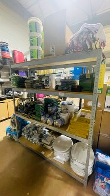 a metal shelf with many items on it in the kitchen
