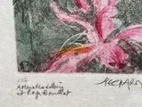 drawing of a pink flower in a black frame on a table