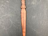 a wooden spoon with a wooden handle on a black surface