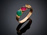 a close up of a gold ring with three different colored stones