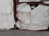 a box full of clothes and a laptop on the floor