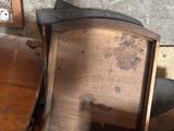 a wooden table and chairs in a room with a wall