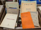 many books in a box on a table
