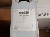 a bottle of liquid sitting on top of a cardboard box