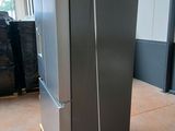 two refrigerators that are on a pallet in a warehouse