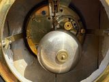 a close up of a clock that is on a table