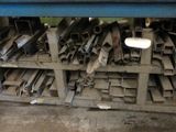 a pile of metal pipes and pipes on a shelf