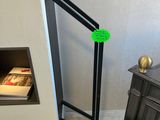 a black stove with a green sticker on it in the corner of a room