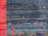a close up of a colorful rug on a wooden floor