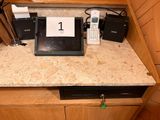 a picture of a counter top with a laptop and other electronics on it