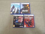 trois boîtes de jeux PlayStation posées les unes à côté des autres sur un canapé