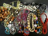 a lot of beads and necklaces on a table