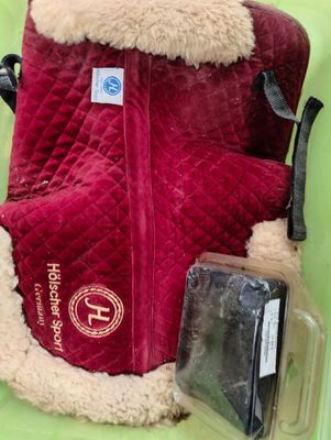 a red backpack with a fur lining and a cell phone in it