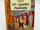 livre pour enfants français, *Les Cigares du Pharaon*, avec l'illustration d'un homme et d'un chien