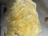 a bag of food sitting on the floor next to a pair of shoes
