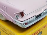 a pink toy car sitting on top of a yellow box