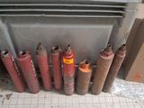 many different types of propane gas cylinders in a bin