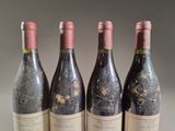 three bottles of red wine are lined up on a table