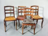 four wooden chairs with a leopard print seat pad on them
