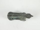 a small statue of a cat on a white surface