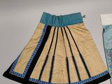 two skirts that are next to each other on a table