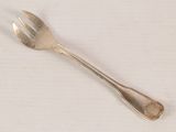a silver spoon and a fork on a white table