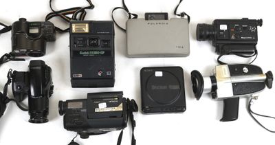 a lot of different types of cameras on the table