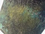 a close up of a vase on a white surface