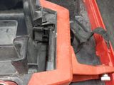 a red tool box with a tool in it on the ground