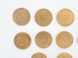 six different types of gold coins on a white surface